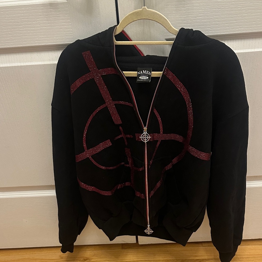 Named Collective black hoodie with red circular  rhinestone design